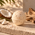 COAST coconut water and driftwood bath bomb by Topanga Republic on natural limestone with weathered driftwood.